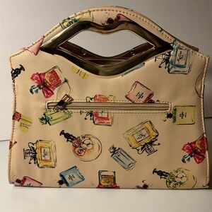 Khaki colored with perfume bottles and lips handle With gold colored hardware